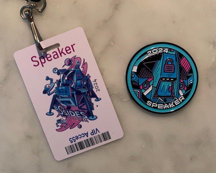 "Presenter's badge and medallion at BSidesPGH conference"
