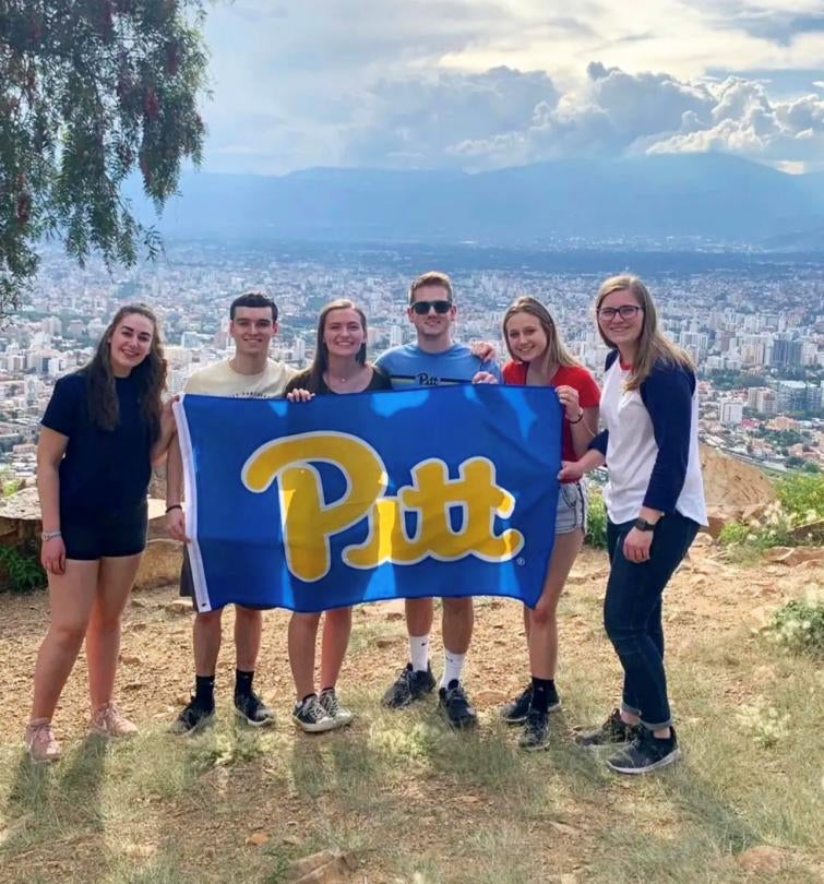 Pitt students in Bolivia with Pitt flag