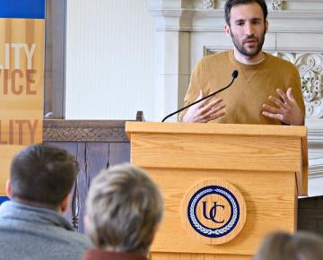 Male at podium speaking