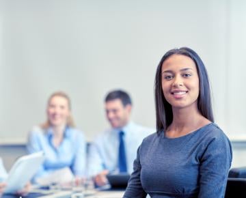 group of smiling businesspeople meeting in office