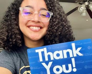 Student with thank you sign