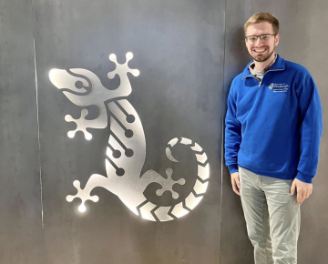 Student poses at internship with Gecko Robotics