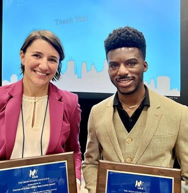 Dr. Carissa Slotterback and Rashad Williams hold their awards
