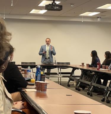 Topher Hoffmann addresses GSPIA students in a classroom